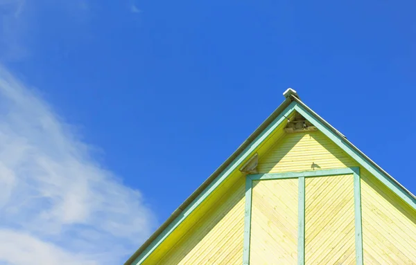 Top Fragment Rustic Yellow Wooden Building Swallows Nests Roof Blue — Stock Photo, Image