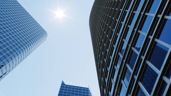 Low angle view of skyscrapers. Skyscrapers looking up perspective. Bottom view of modern skyscrapers in business district in daylight. Business concept of success, 3D illustration — Stock Photo, Image