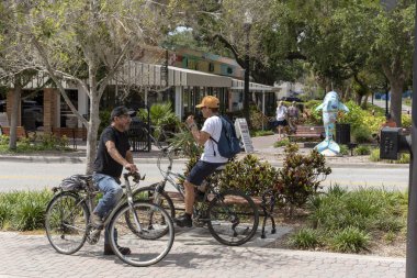 Dunedin, Florida, ABD. İki adam bisiklet şehir merkezi sohbet.