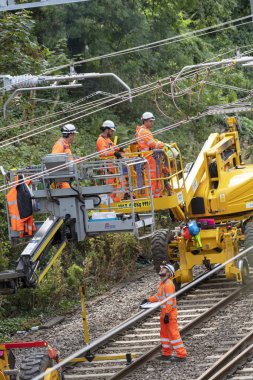 Newbury Station, Berkshire UK. Engineers working on the electrification  of the railway line at Newbury earlier today. The Great Western Railway region is closed in ths area until August 31st.  clipart