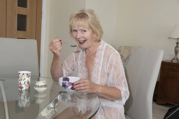 Attractive Elderly Woman Eating Breakfast — Stock Photo, Image