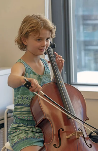 Young music student playing a cello