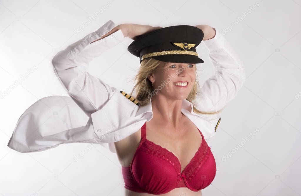 Woman in uniform having her shirt and hair being blown in a breeze