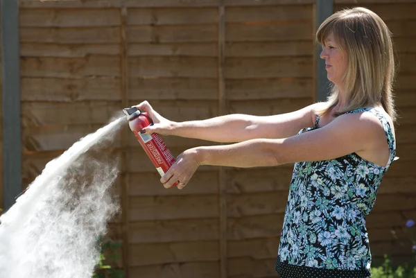 Woman Using Dry Powder Fire Extinguisher — Stock Photo, Image