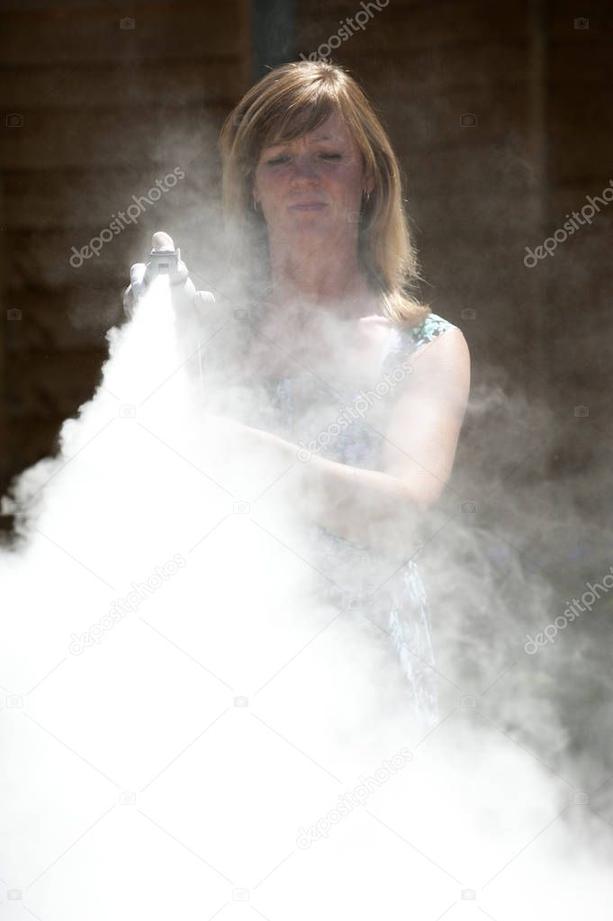Woman using a dry powder  fire extinguisher