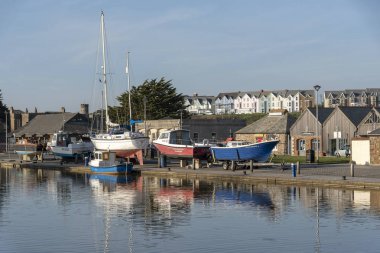 Bude, North Cornwall, England, UK. February 2019. Bude Canal with boats on the wharf, out of the water for winter. clipart