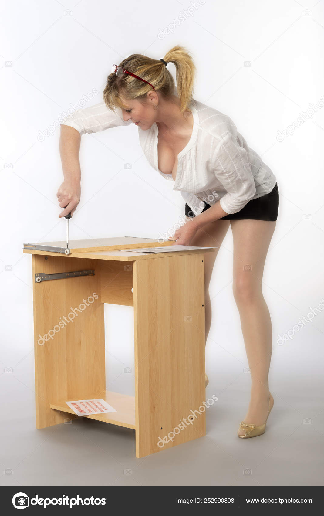 Woman Constructing Personal Computer Desk Flatpack Using