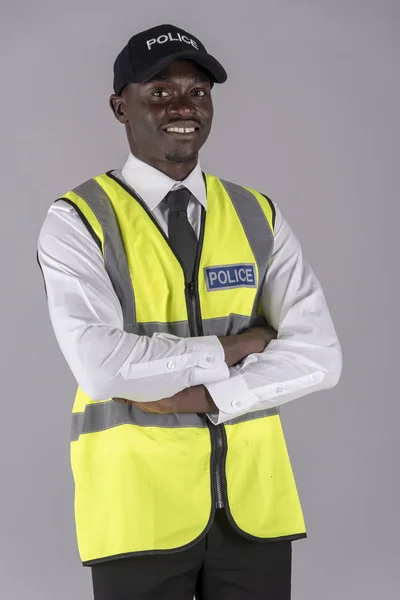 Portrait of a smiling police officer in uniform with arms folded. April 2019