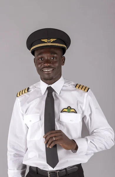 Portrait of a young airline pilot wearing a captain\'s uniform.