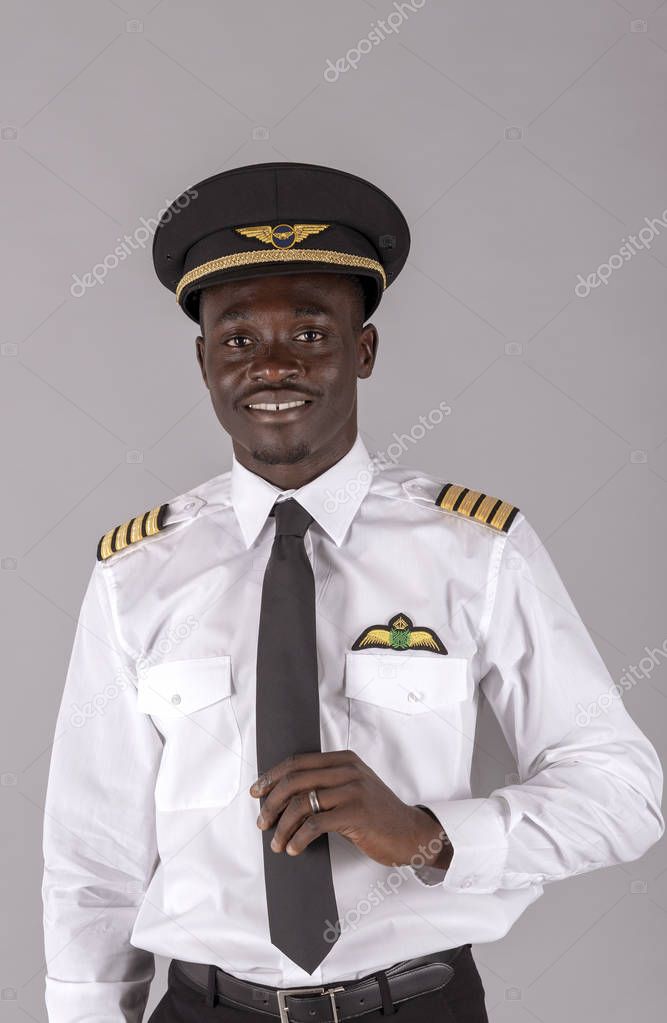  Portrait of a young airline pilot wearing a captain's uniform.