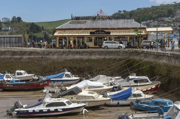 stock image Dartmouth, South Devon, England, UK. May 2019. The old railway station now a cafe bar and old harbour at low tide