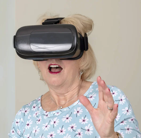 Portsmouth UK, May 2019. Elderly woman having fun wearing virtual reality goggles
