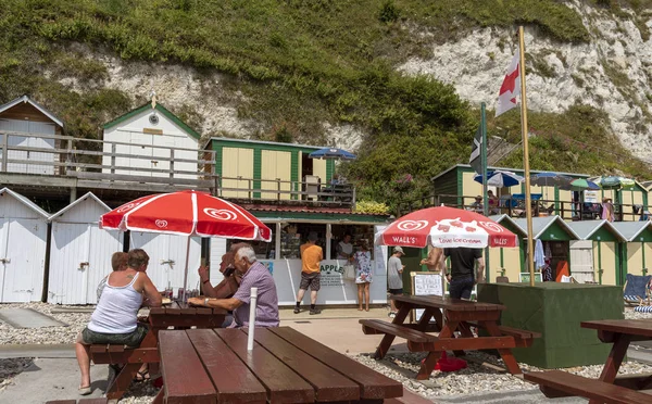 Beer near Seaton, Devon, England, UK. June 2019. Beer beach on the Jurassic Coast in East Devon.  Self service cafe on the beach at Beer with white chalk cliffs.