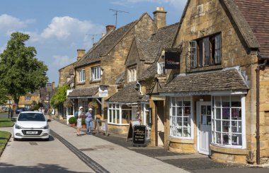 Broadway, Worcestershire,, England, UK. August 2019.  Shopping area of this beautiful Cotswold village. Buildings  with honey coloured limestone  brickwork. clipart