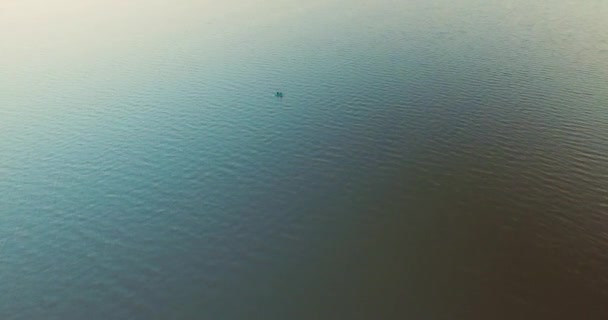 Flight over ocean blue water and alone rowing boat with man — Stock Video