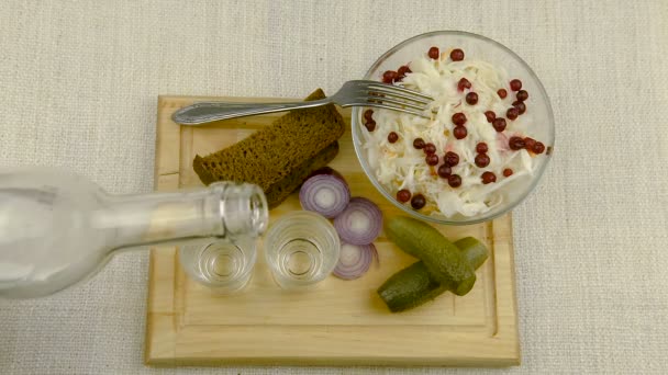 Vodka is poured into a glass, on the table is a traditional Russian snack. — Stock Footage Vodka Poured Glass Table Traditional Russian Snack Royalty Free Stock Video