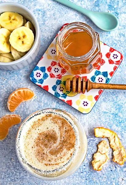 Vegan banana shake with cocos milk, tangerine, honey and cinnamon swirl