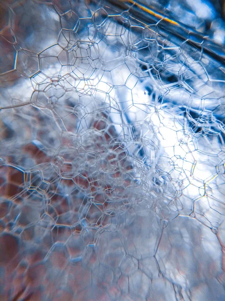 Blue lather soap suds bubble light texture background pattern macro photo