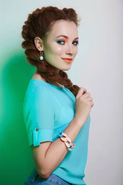 happy beauty girl with braids hairstyle. beautiful smiling woman with color make-up