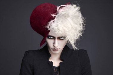 fashion portrait of halloween make-up woman in hat.white skin and hair fairy girl