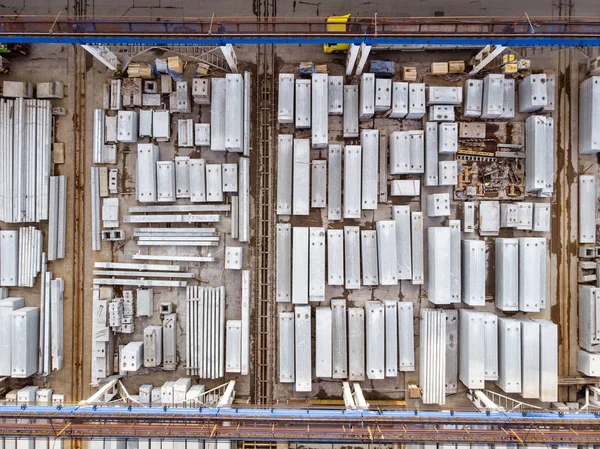 Warehouse of bricks, concrete blocks and trucks by drone