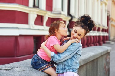 Sevgi dolu bir anne ve kızı sokaklarda. Bayan casual giyim kavramı