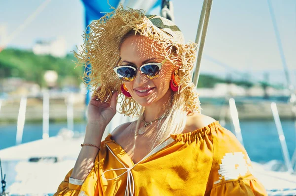 Attractive young woman on a yacht on a summer day. Beautiful fashionable woman in summer outdoors., young happy woman on the background of sea boats.