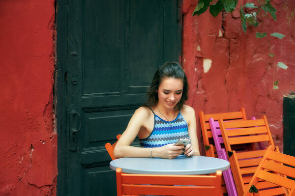 Young girl with mobile phone . The girl uses technology in everyday life