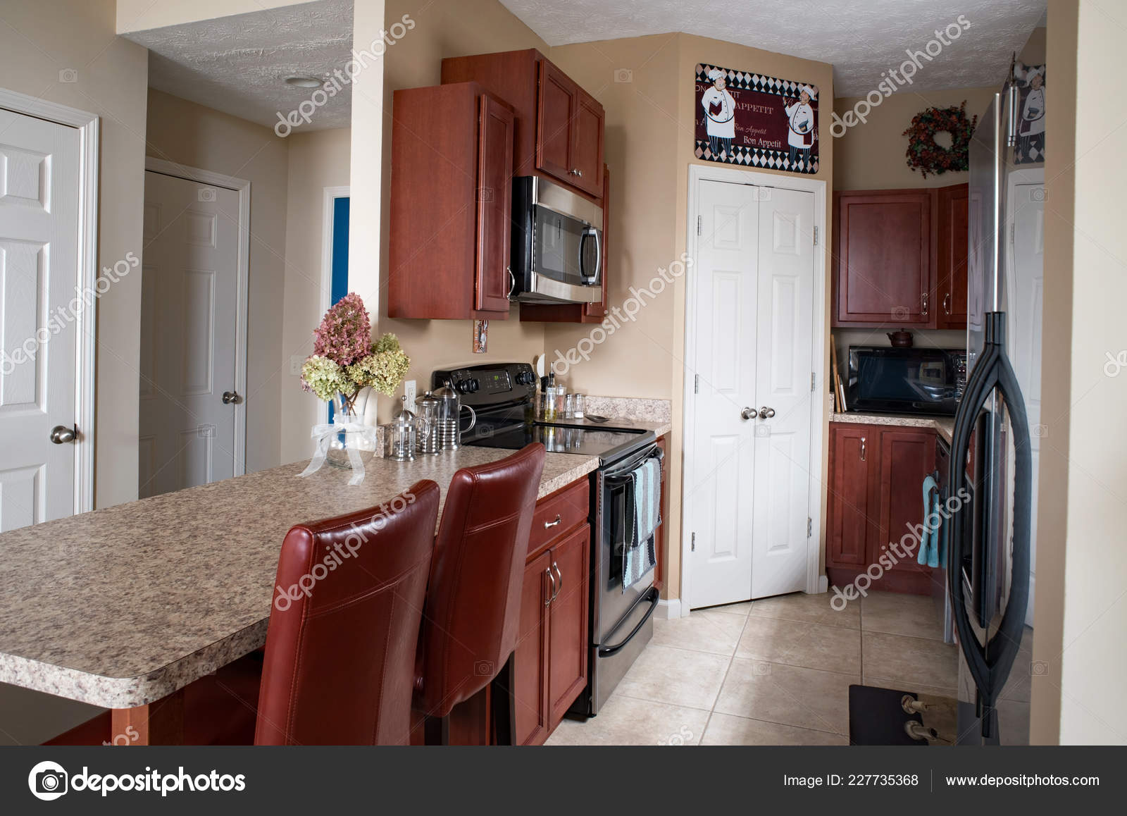 Condo Galley Kitchen Cherry Cabinets Stock Photo