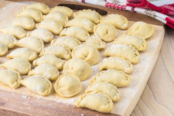 Sığır eti köfte el yapımı farklı şekiller kesme tahtası üzerinde Kapat