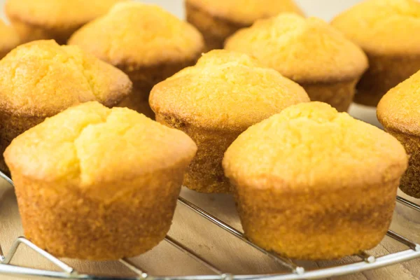 Mini cornbread muffins on cooling tray.