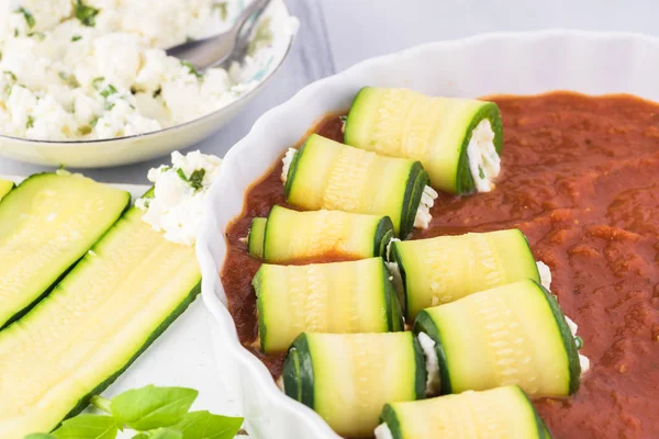 Zucchini rollups with cheese in marinara sauce. — Stock Photo, Image