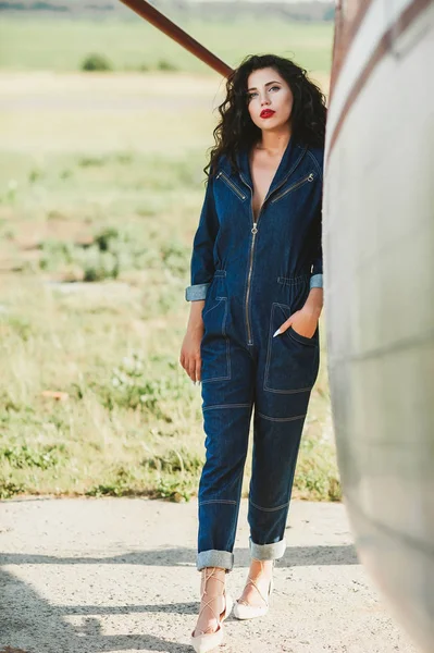 Sexy Girl Curly Hair Denim Overalls Airplane — Stock Photo, Image