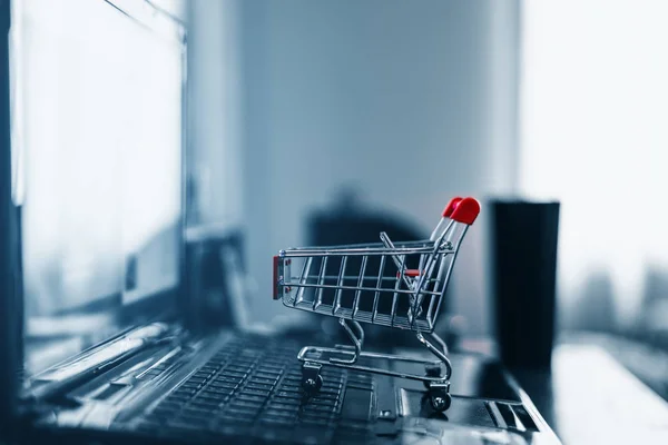 Shopping cart on computer laptop. Online shopping