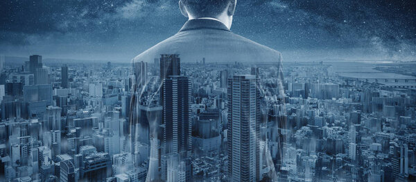 Double exposure businessman and panoramic Osaka city skyscraper in Japan