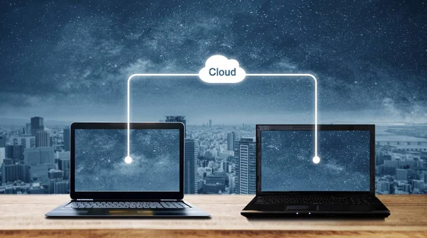 Computer laptops sharing data through cloud storage computing. Cloud computing and computer network concepts