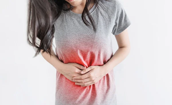 Young Woman Holding Stomach Red Highlight Royalty Free Stock Images