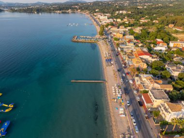 Aerial drone view of Dassia beach resort and bay in Corfu, Greece.