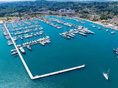 Sweeping aerial drone view of Gouvia Marina in Corfu, Greece. A major Ionian Sea port filled with luxury yachts and sailboats, representing a prime summer travel destination in September