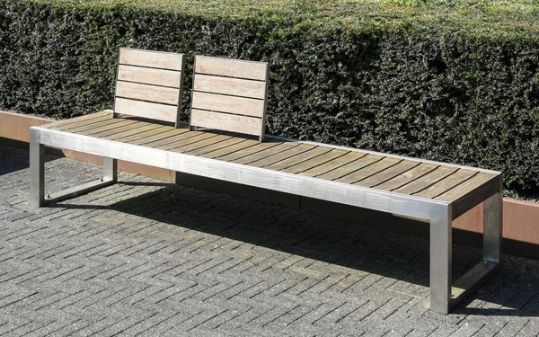 Elegant and practical furniture made of stainless steel and wooden elements in park