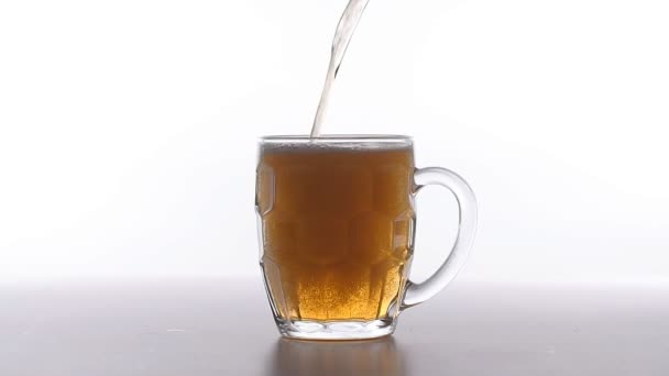 Beer poured into glass on white background — Stock Video