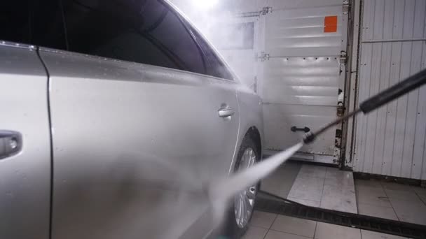 Hombre lavando coche bajo agua de alta presión — Vídeos de Stock