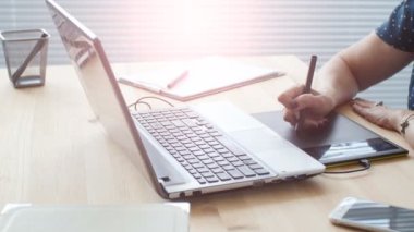 Grafik tasarımcı modern ofiste çalışırken dijital grafik tablet kullanan kadın yaşlı