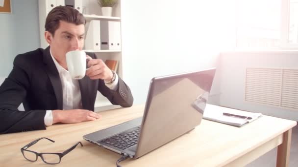 Młody człowiek pracuje na laptopie w biurze — Wideo stockowe