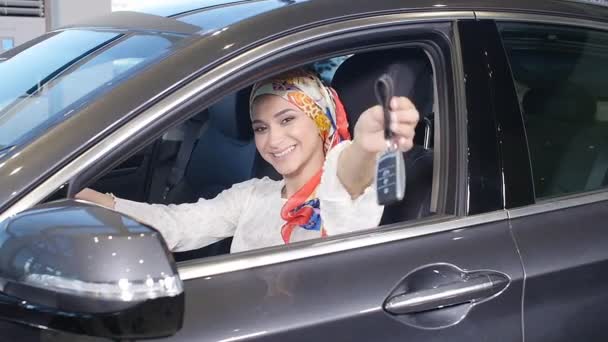 Concept of buying a car. Happy muslim woman holding car key. — Stock Video