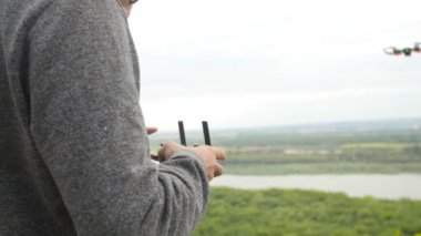 Man controlling a quadrocopter drone