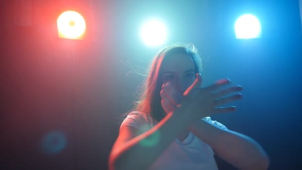 Mladá dívka tančí v barevné světlo — Stock video