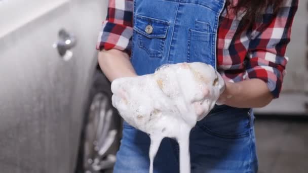 Jeune femme lavant une voiture avec une éponge — Video