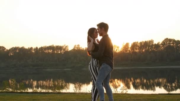 Concept van liefde en relaties. Jong koppel dansen bij zonsondergang — Stockvideo