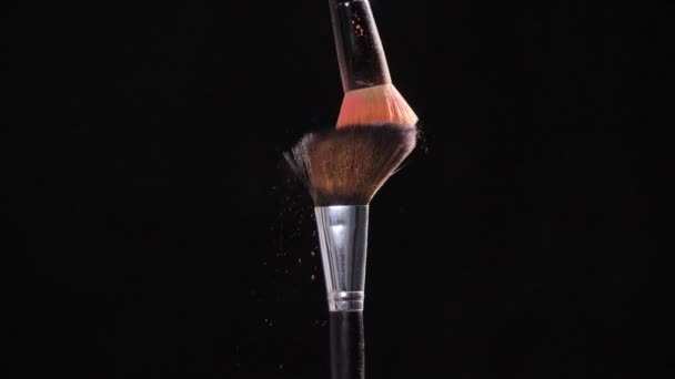 Two Make-up brush with pink powder on black background — Stock Video
